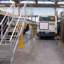 Stairs and platform / walkway for vehicule maintenance Industrial aluminium stairs and platform for bus maintenance in a repair shop / garage.